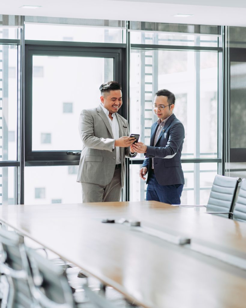 two men talking in office building